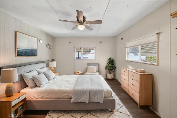 a spacious bedroom with a large bed and a chandelier