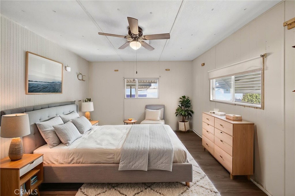 12656 2nd Street, Unit 55 Yucaipa, CA 92399 - Photo 23 of 29 a spacious bedroom with a large bed and a chandelier