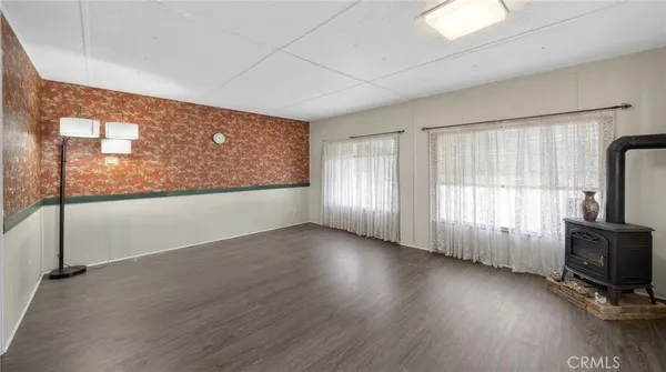 a view of a livingroom with wooden floor and a window