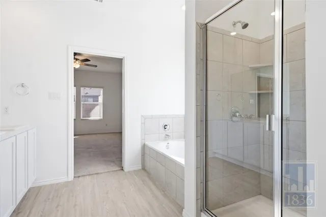 a bathroom with a bathtub and shower