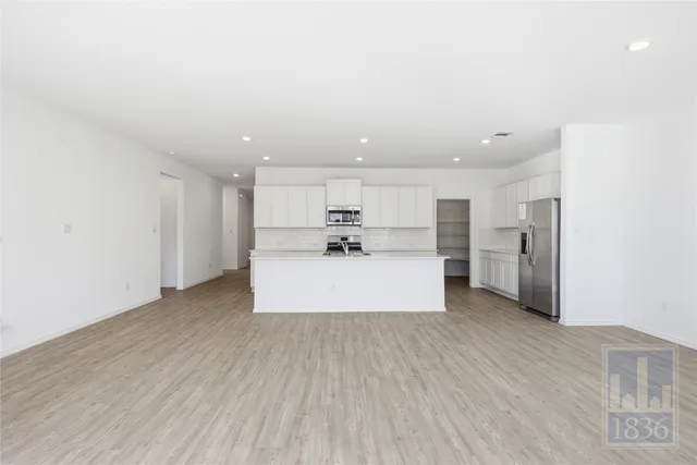 a view of kitchen with refrigerator sink microwave and cabinets