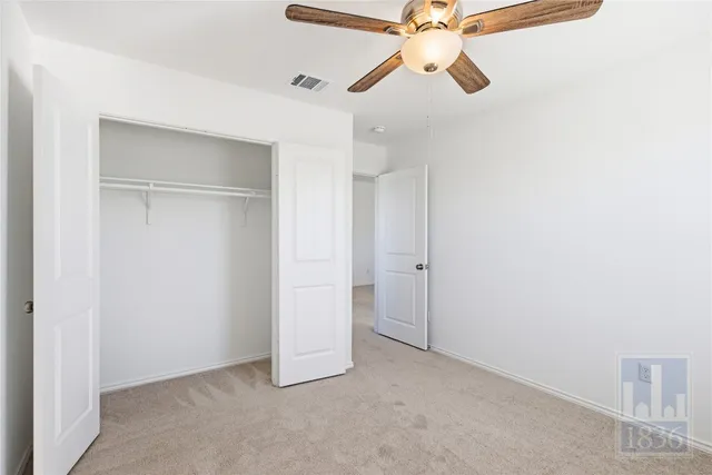 a view of room with a ceiling fan