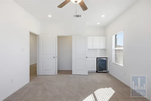 a view of room with window and ceiling fan