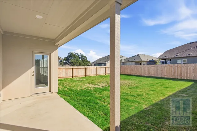 a view of backyard with porch and entertaining space