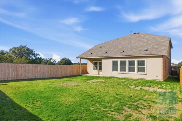 a view of a house with backyard and porch