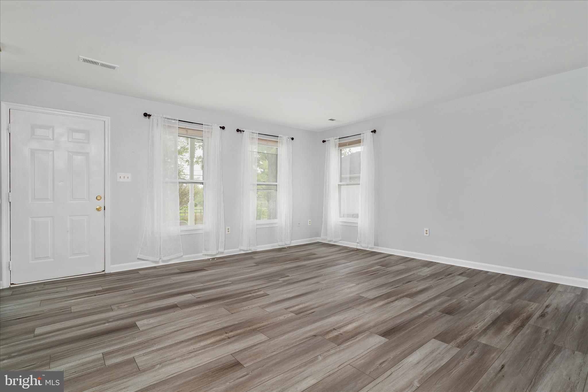 3961 Rectortown Road Marshall, VA 20115 - Photo 3 of 35 a view of an empty room with wooden floor and window