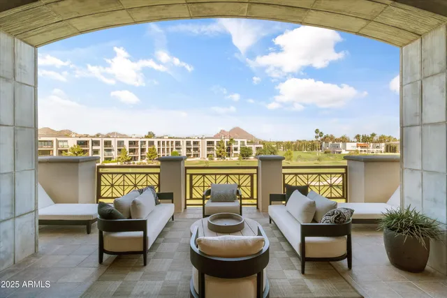 a living room with furniture and a view of kitchen