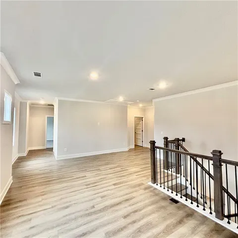 a front view of a house with a garden and plants