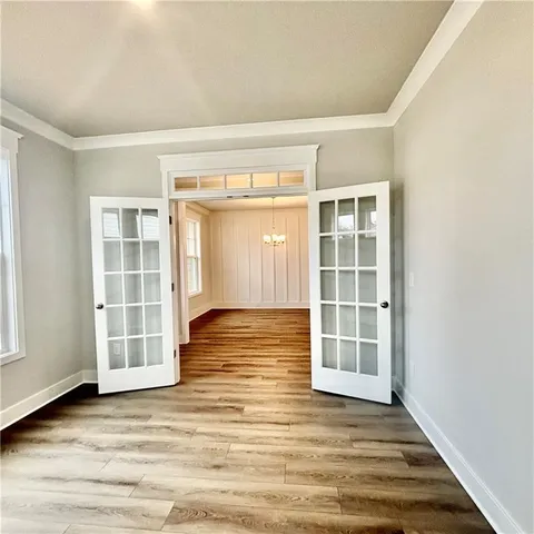 a view of a hallway with wooden floor and staircase