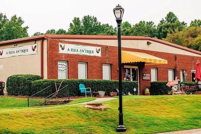 a front view of a building with cars parked
