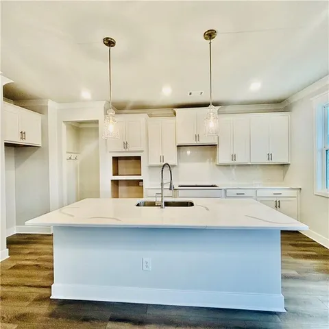 an aerial view of a house with swimming pool and outdoor seating