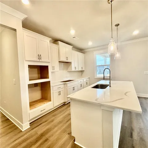 a view of outdoor sitting area with furniture and lake view