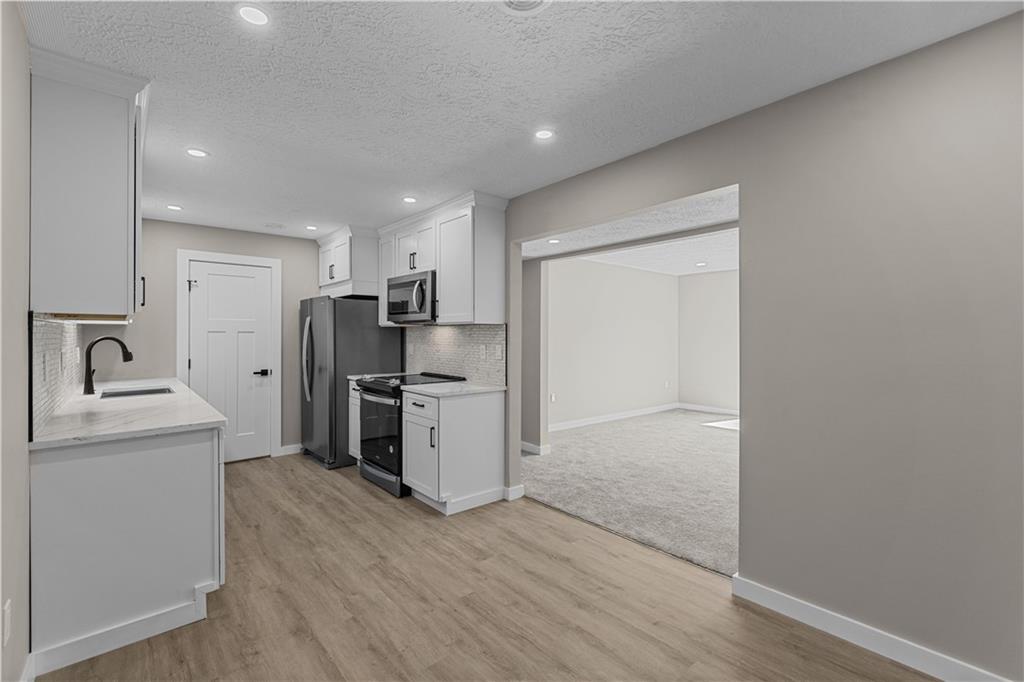 300 Gilkeson Road, Unit 10B Pittsburgh, PA 15228 - Photo 6 of 25 a kitchen with stainless steel appliances a refrigerator and a stove top oven