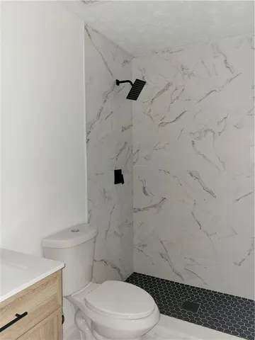a white toilet and shower curtain