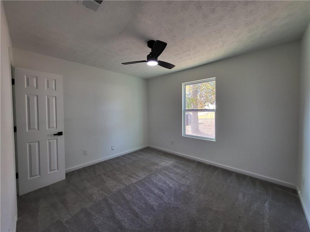5729 Rock Road Union City, GA 30291 - Photo 9 of 17 an empty room with windows and fan