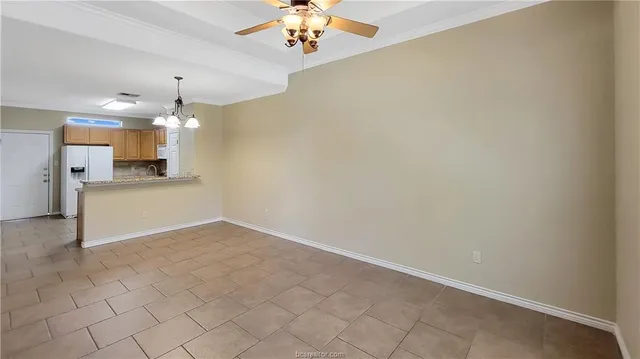 wooden floor in an empty room with a kitchen