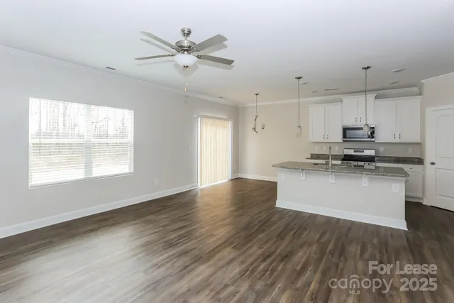 a view of kitchen with sink microwave and stove