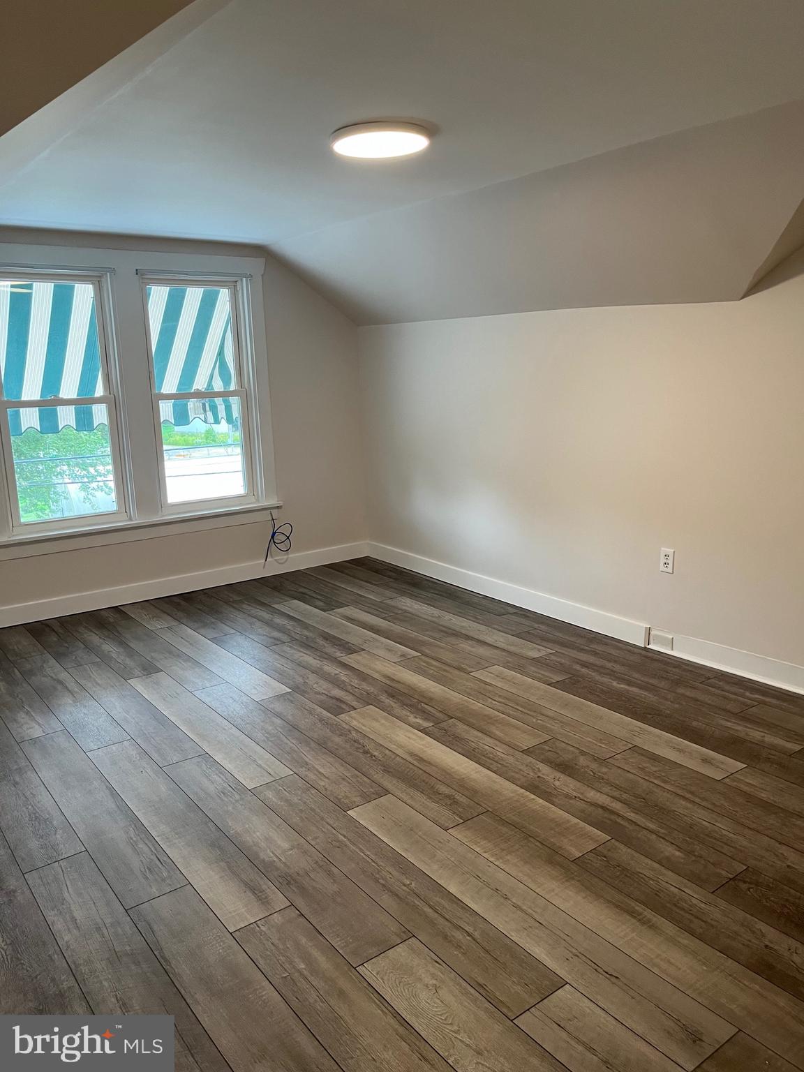 917 A A N Old Road, Unit 2 Strasburg, PA 17579 - Photo 5 of 7 an empty room with wooden floor and windows