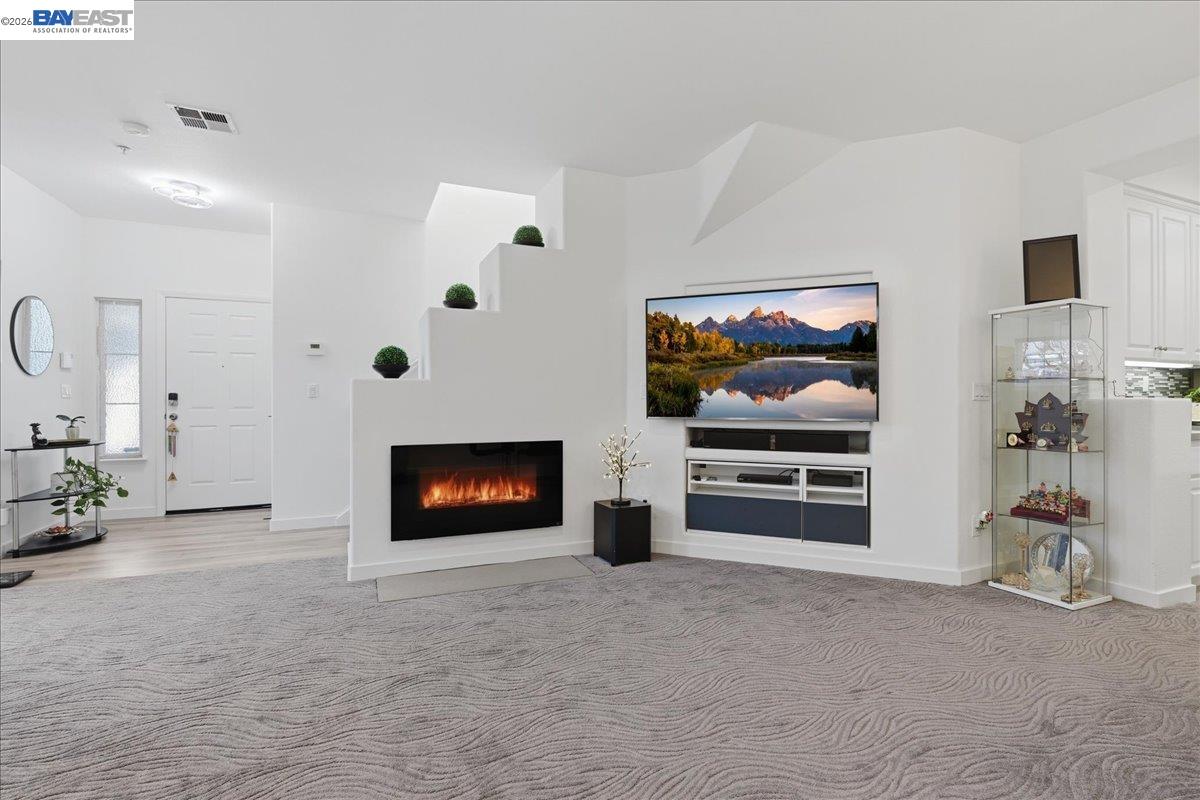 130 Sutter Creek Lane San Ramon, CA 94583 - Photo 13 of 56 a living room with furniture a flat screen tv and a fireplace