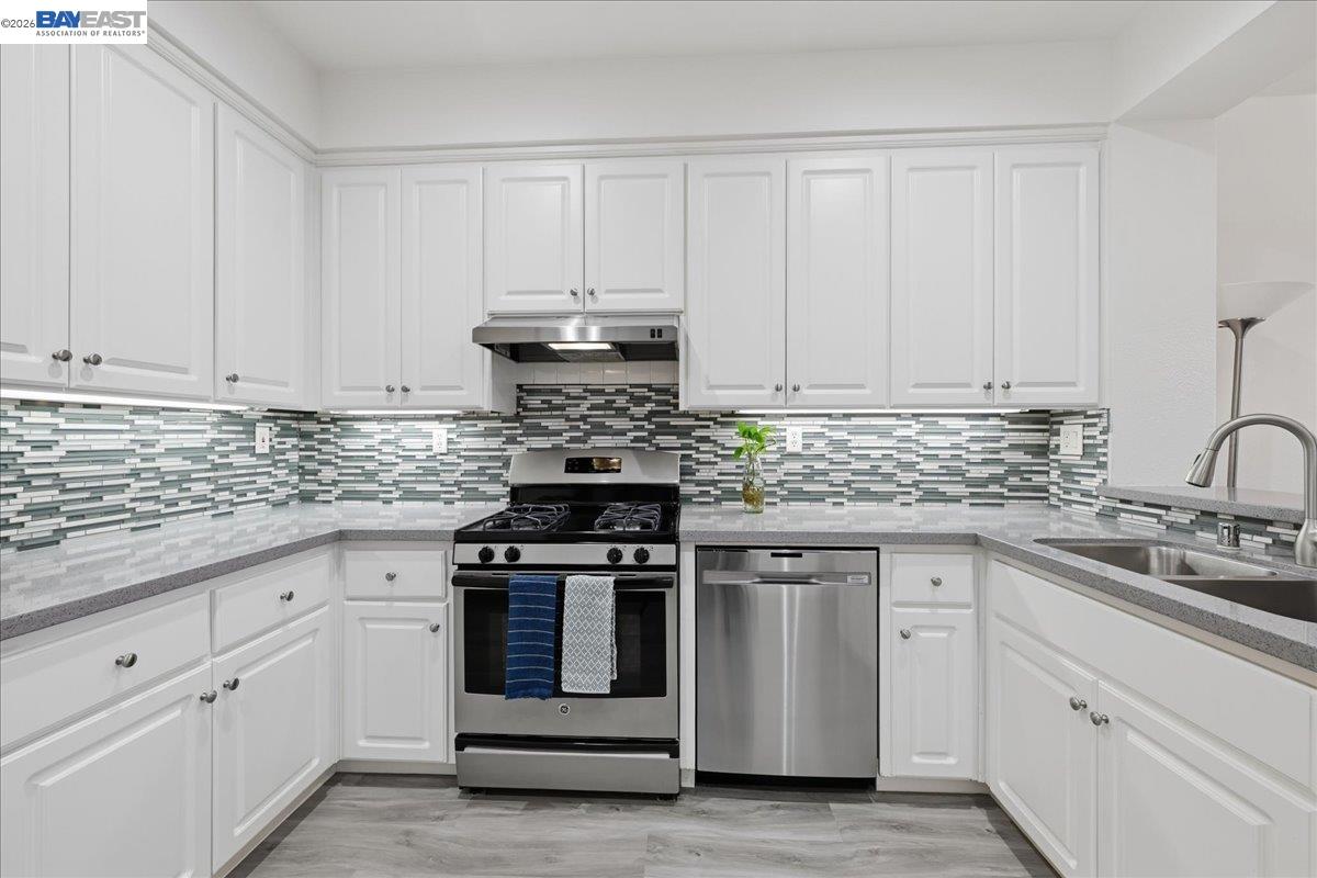 130 Sutter Creek Lane San Ramon, CA 94583 - Photo 16 of 56 a kitchen with white cabinets and appliances
