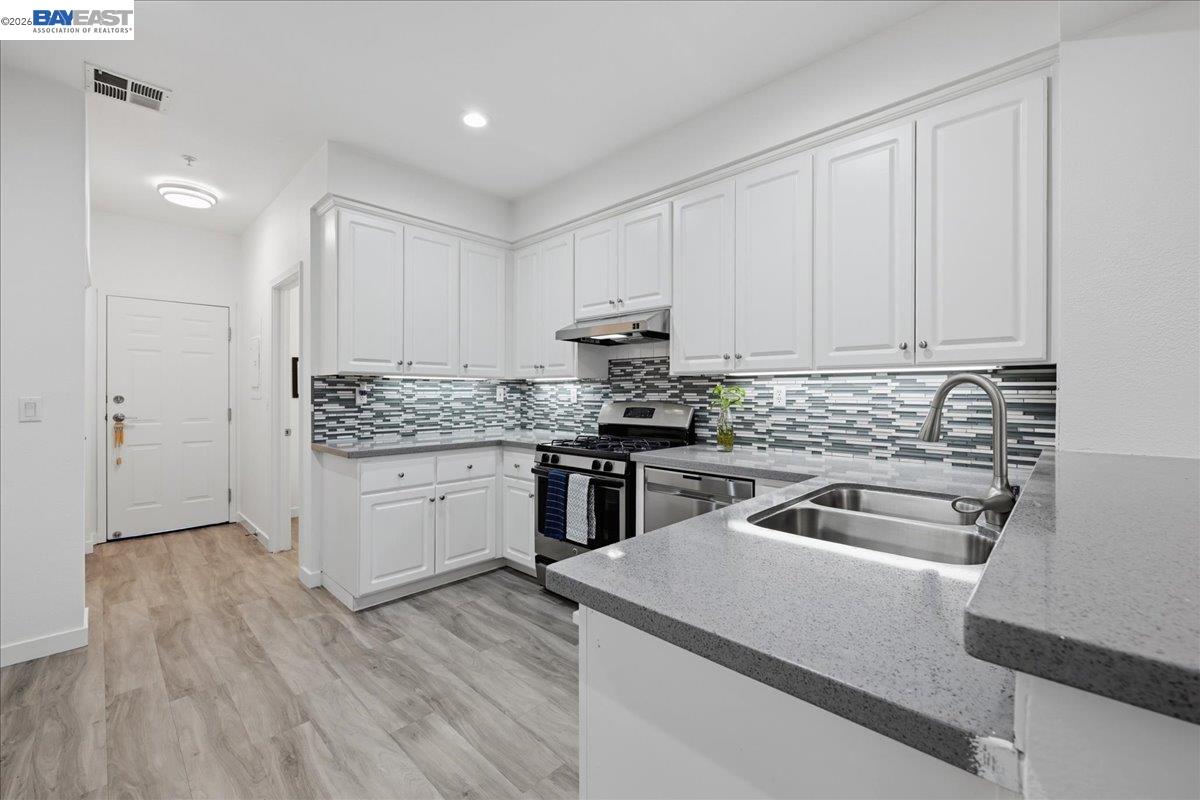 130 Sutter Creek Lane San Ramon, CA 94583 - Photo 17 of 56 a kitchen with granite countertop a sink cabinets and stainless steel appliances