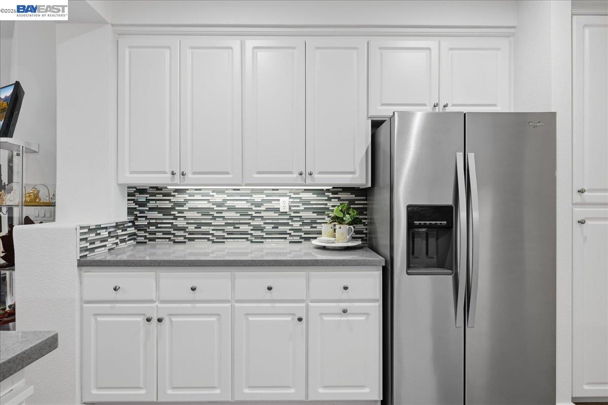130 Sutter Creek Lane San Ramon, CA 94583 - Photo 18 of 56 a kitchen with granite countertop a refrigerator and cabinets