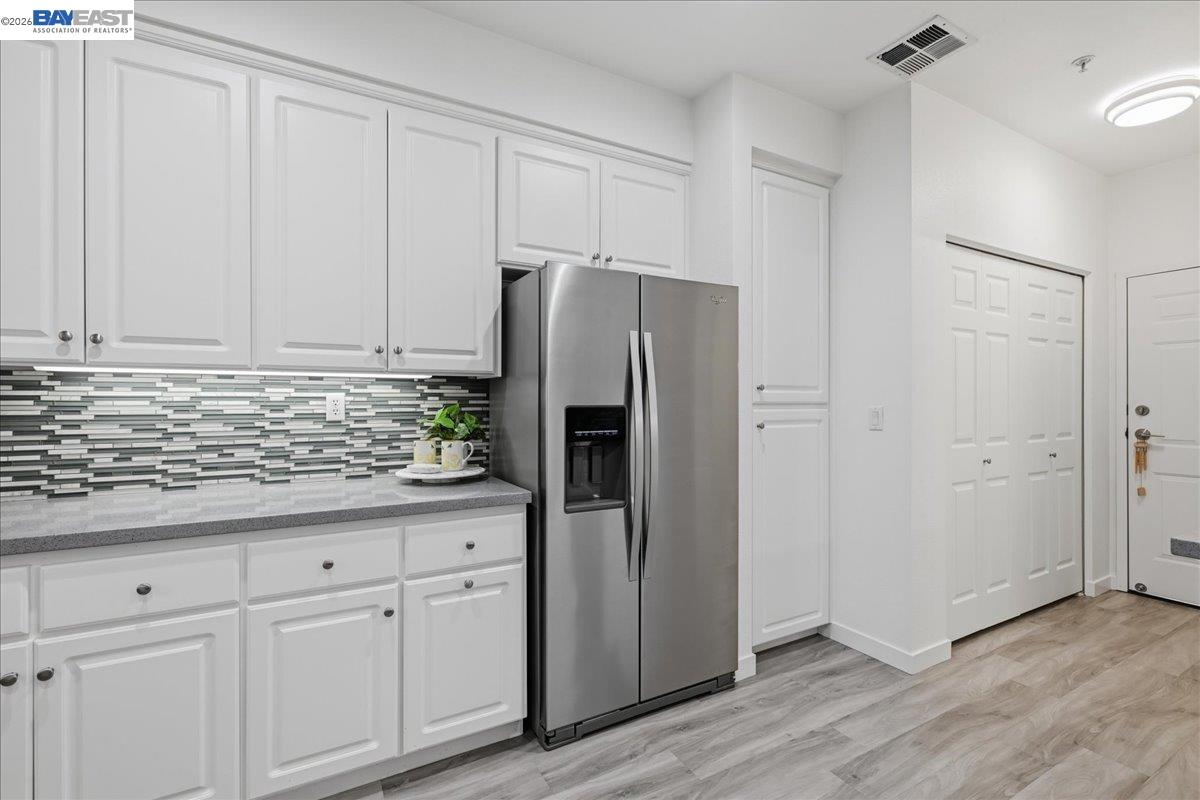 130 Sutter Creek Lane San Ramon, CA 94583 - Photo 19 of 56 a kitchen with stainless steel appliances white cabinets and a refrigerator