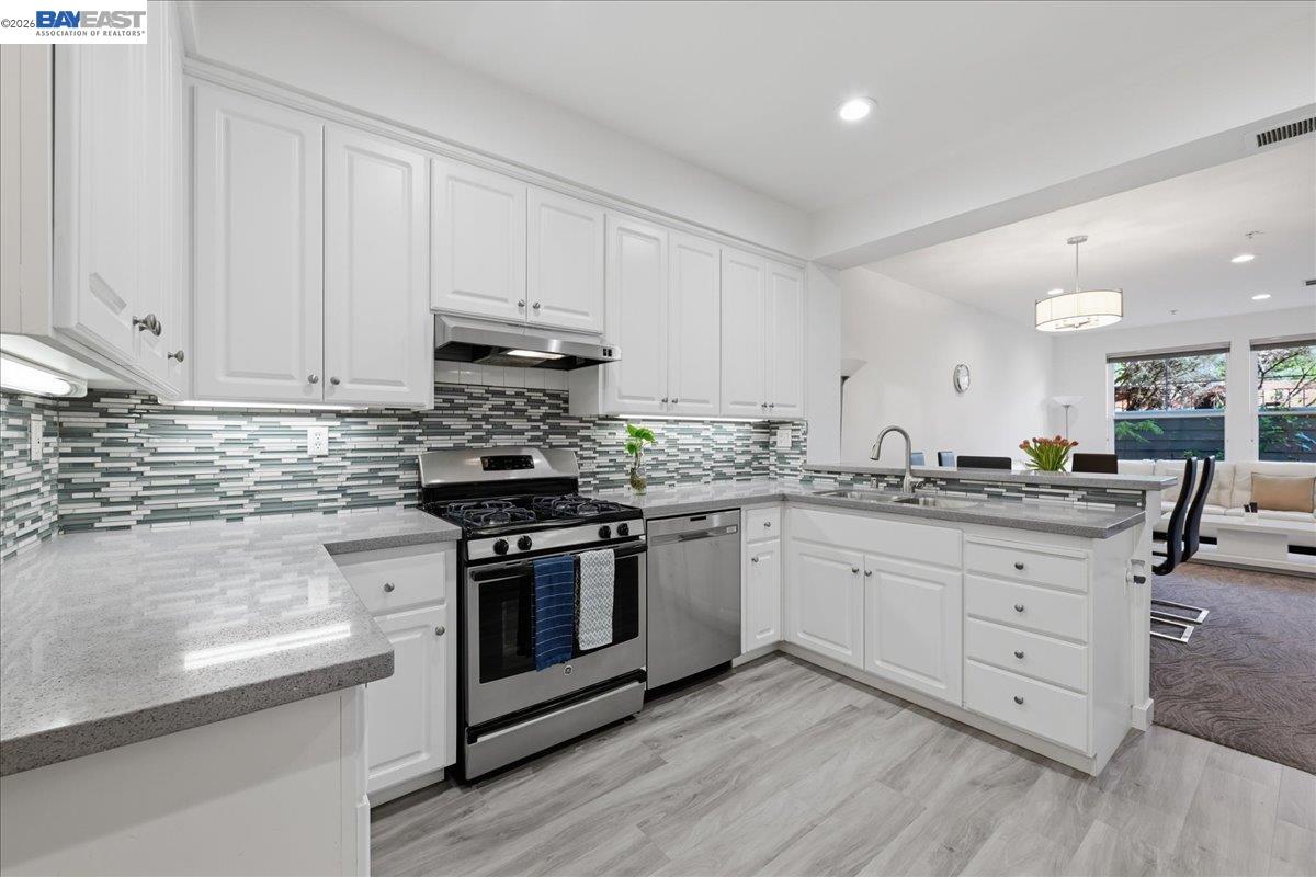 130 Sutter Creek Lane San Ramon, CA 94583 - Photo 20 of 56 a kitchen with granite countertop white cabinets and white appliances