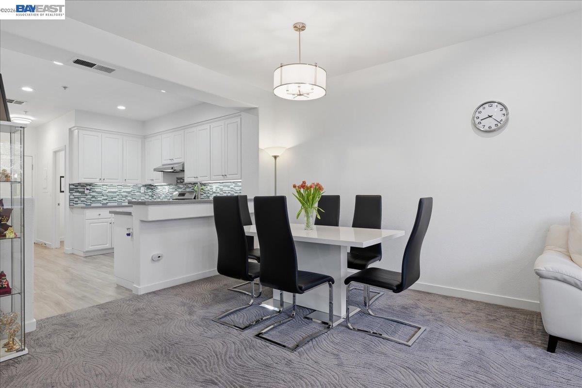 130 Sutter Creek Lane San Ramon, CA 94583 - Photo 22 of 56 a dining room filled chandelier and kitchen view