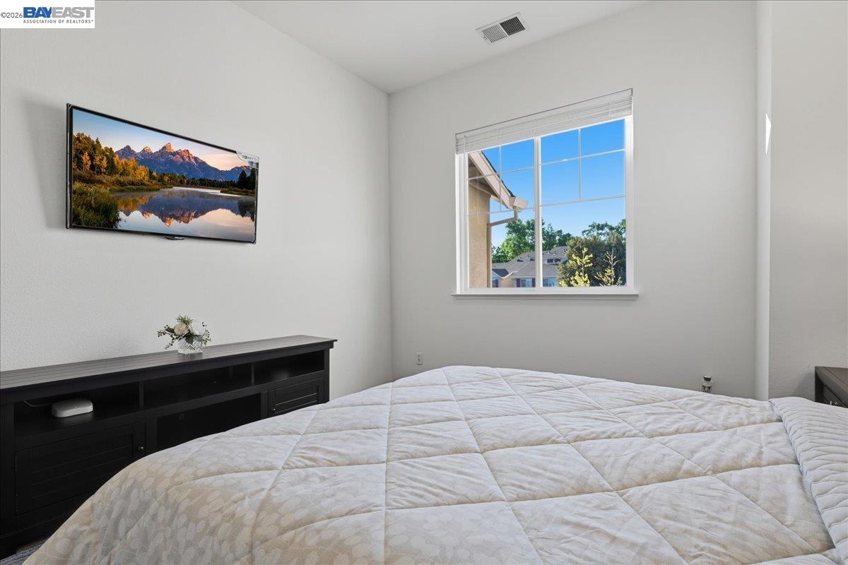 130 Sutter Creek Lane San Ramon, CA 94583 - Photo 26 of 56 a bedroom with a bed and a painting on the wall