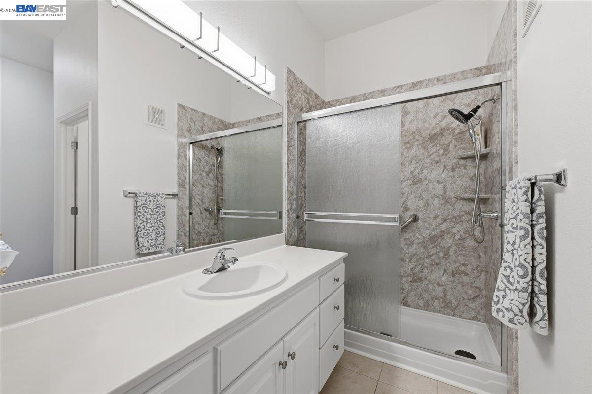 130 Sutter Creek Lane San Ramon, CA 94583 - Photo 30 of 56 a bathroom with a shower sink and mirror