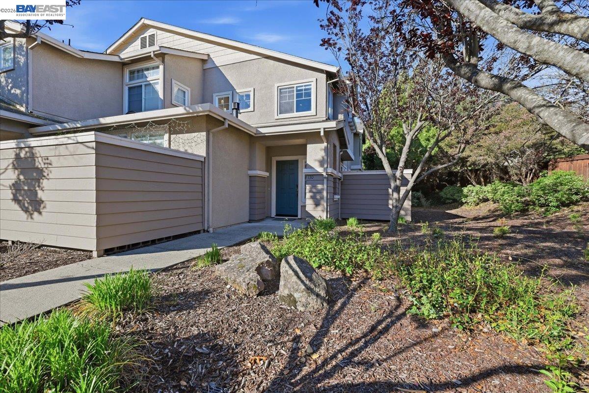 130 Sutter Creek Lane San Ramon, CA 94583 - Photo 3 of 56 a view of a white house with large windows and a yard