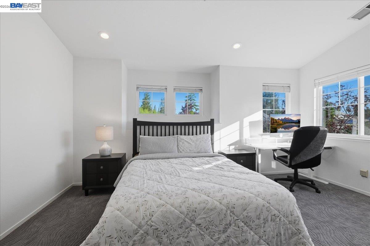 130 Sutter Creek Lane San Ramon, CA 94583 - Photo 36 of 56 a bedroom with a bed a table and a chair