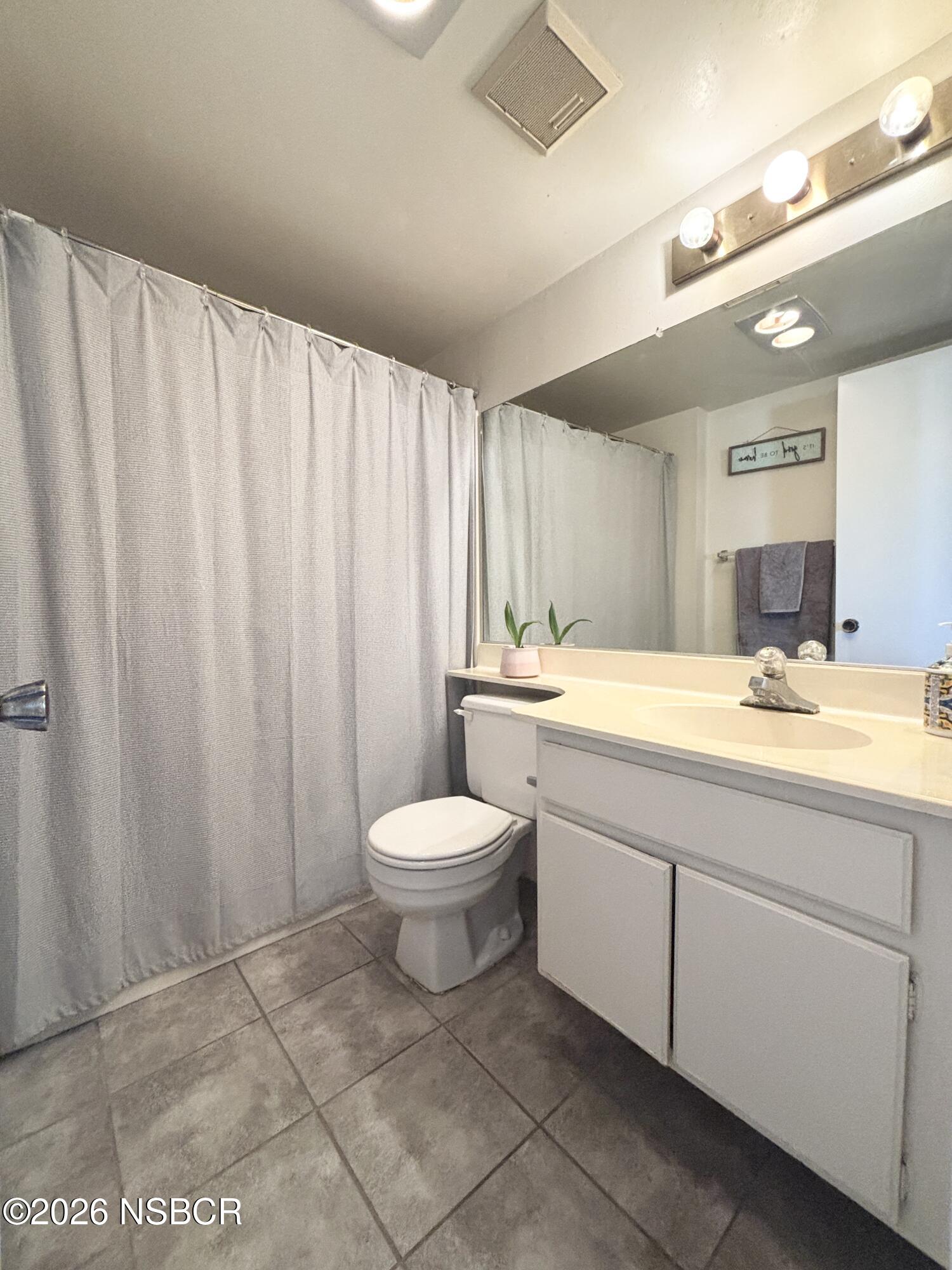 2409 Country Lane Santa Maria, CA 93455 - Photo 4 of 20 a bathroom with a sink a toilet and a mirror