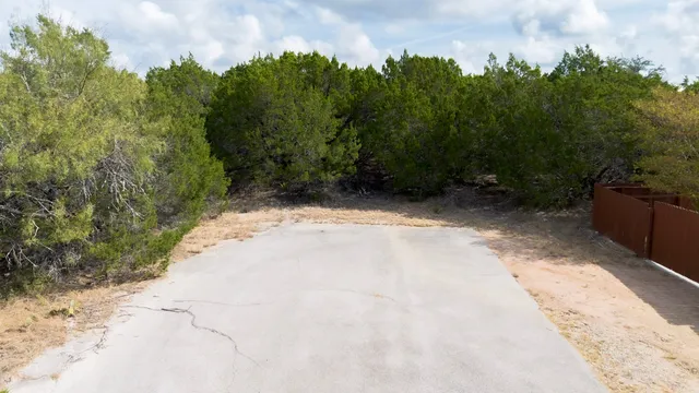 a view of a pathway with a yard