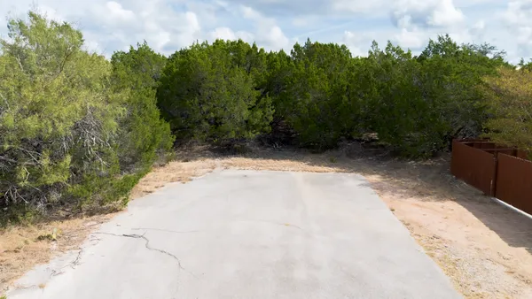 a view of a pathway with a yard