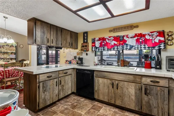 a kitchen with granite countertop a sink stainless steel appliances and cabinets