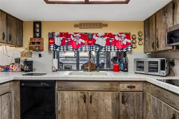 a kitchen with a sink cabinets and a stove