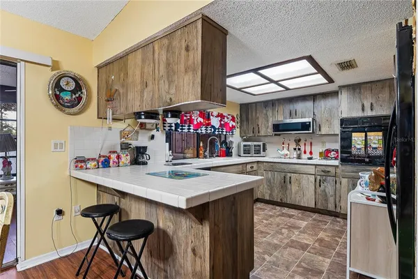 a kitchen with a sink cabinets and wooden floor