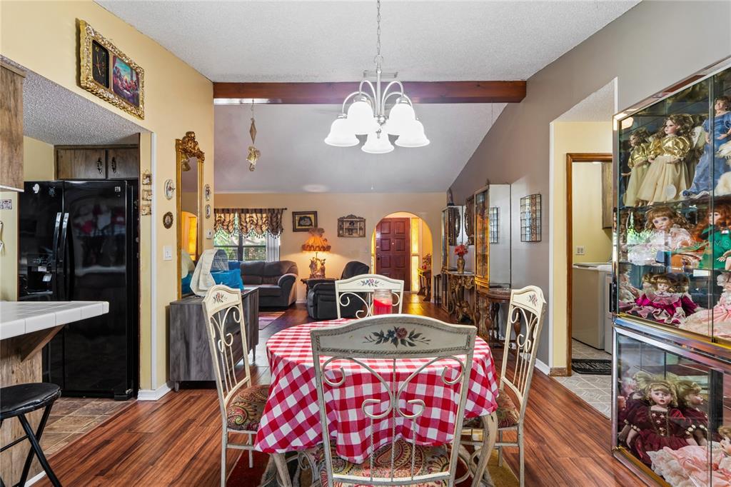 11122 Maderia Street Spring Hill, FL 34609 - Photo 16 of 49 a view of a dining room with furniture and chandelier
