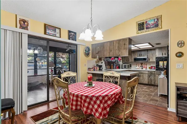 a dining room with furniture a rug and wooden floor