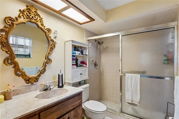a bathroom with a sink toilet and shower