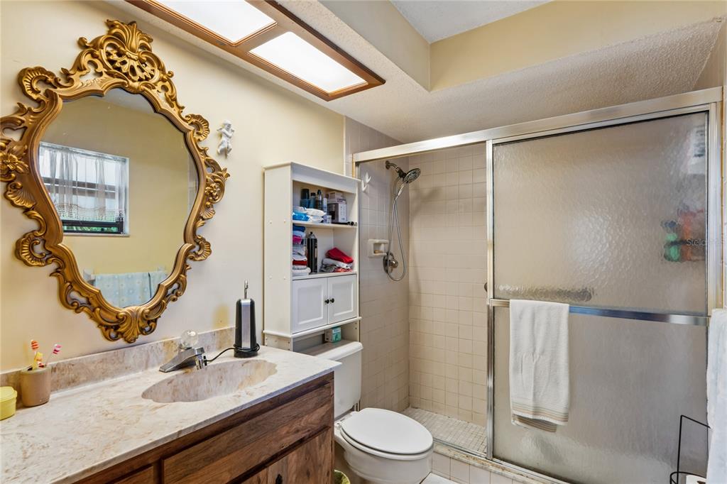 11122 Maderia Street Spring Hill, FL 34609 - Photo 22 of 49 a bathroom with a sink toilet and shower