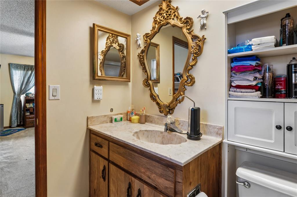 11122 Maderia Street Spring Hill, FL 34609 - Photo 24 of 49 a bathroom with a sink vanity and a mirror