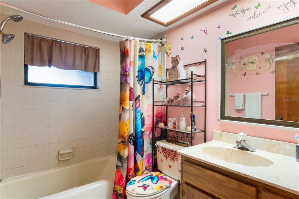 11122 Maderia Street Spring Hill, FL 34609 - Photo 28 of 49 a bathroom with a sink mirror vanity and bathtub