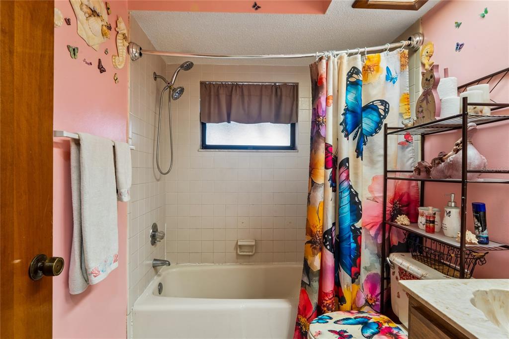 11122 Maderia Street Spring Hill, FL 34609 - Photo 29 of 49 a bathroom with a bathtub and a shower
