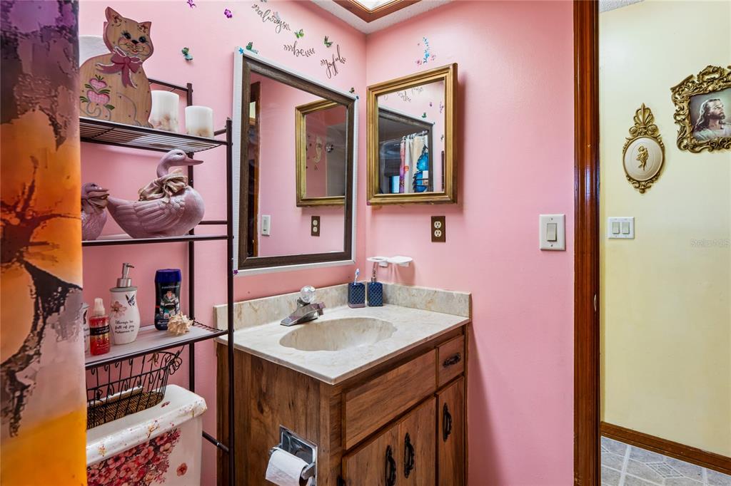 11122 Maderia Street Spring Hill, FL 34609 - Photo 30 of 49 a bathroom with a sink and a mirror