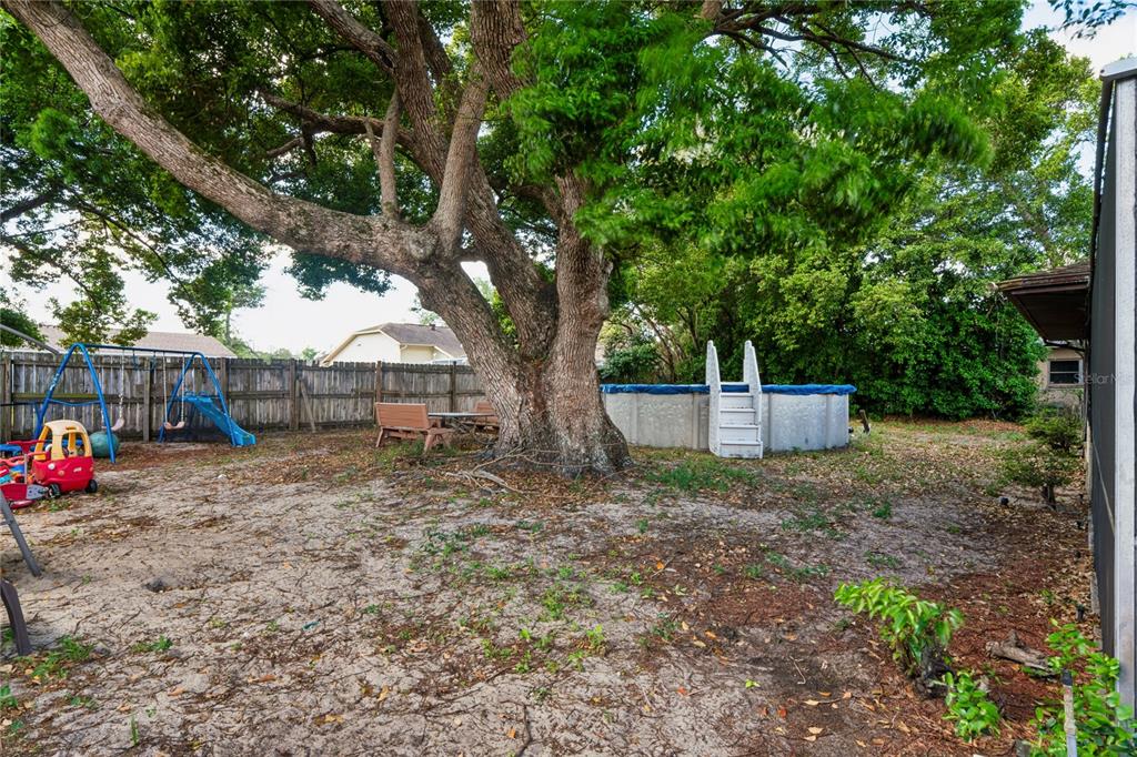 11122 Maderia Street Spring Hill, FL 34609 - Photo 38 of 49 a view of house with backyard and entertaining space