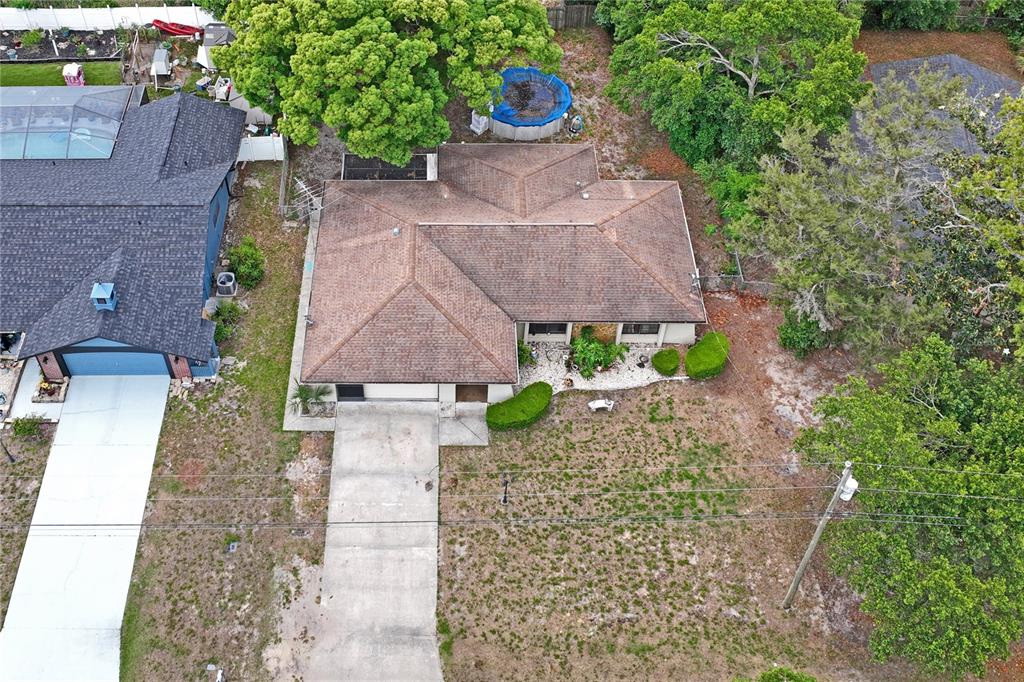 11122 Maderia Street Spring Hill, FL 34609 - Photo 45 of 49 an aerial view of a house with a yard and a large tree