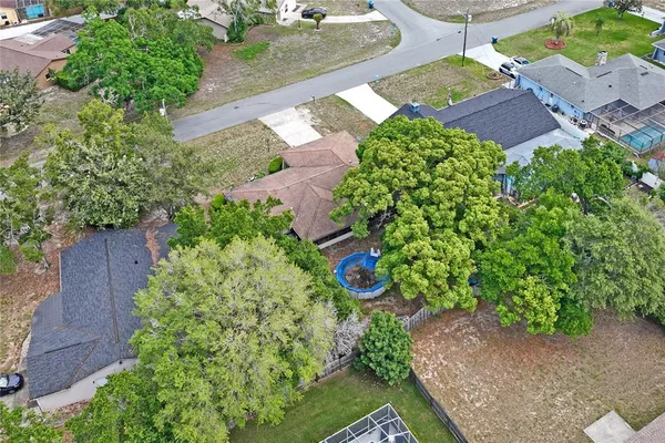 an aerial view of a house with a yard and garden